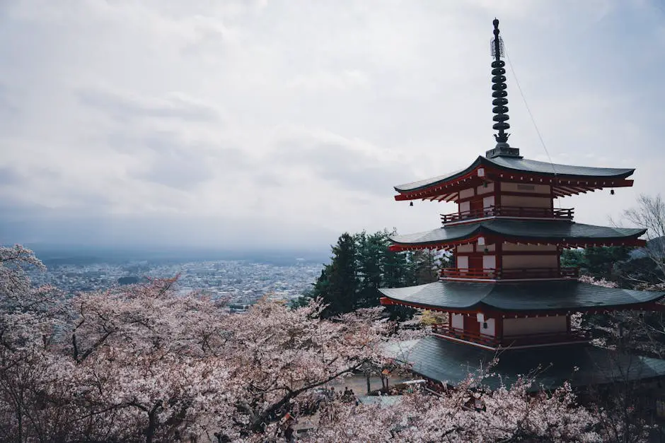 A traditional Japanese temple in Kyoto surrounded by blooming cherry blossom trees, with petals gently falling in the foreground