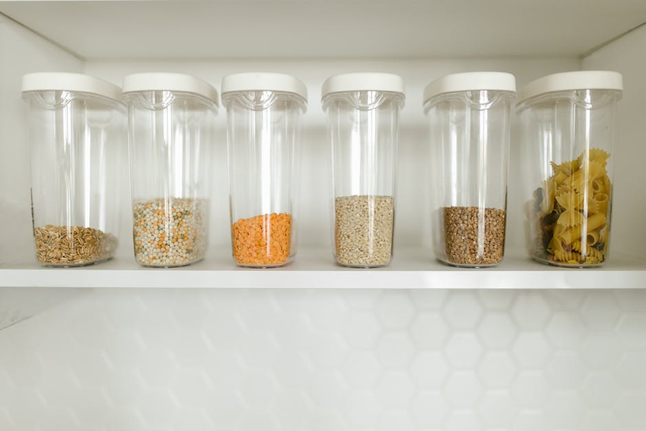 A neatly organized pantry with clear containers and labeled jars
