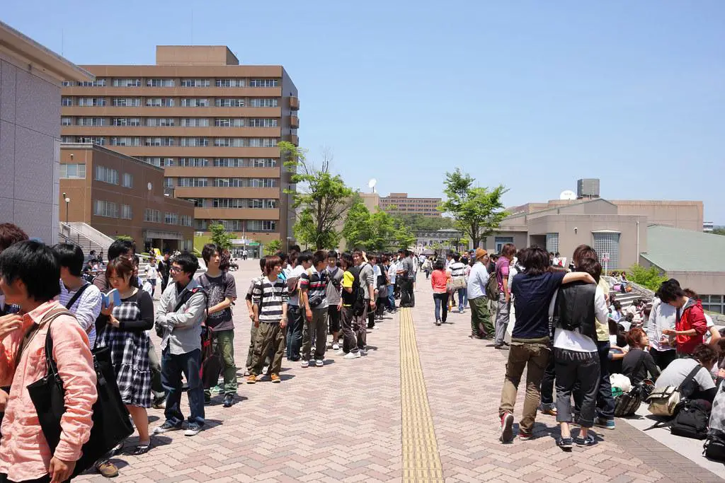 A lively university campus scene in spring with students enjoying outdoor activities